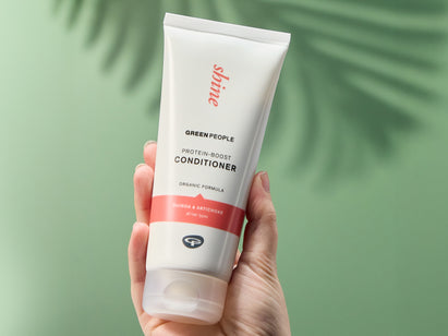 hand holding a green people conditioner