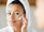 woman applying rich thick moisturiser to face