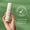 A hand holds a bottle of Vita Min Fix 24-Hour Cream against a green background featuring a dermatologically tested seal.