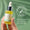 A hand holds a dropper bottle of Green People Anti Ageing Facial Oil against a green background with a dermatologically tested seal.