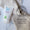 A tube of Organic Babies Baby Wash & Shampoo Lavender rests on a beige linen cloth alongside a Dermatologically Tested seal.