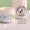 An open white tub of Organic Babies Mum & Baby Rescue Balm sits on a marble surface beside a dermatologically tested stamp.
