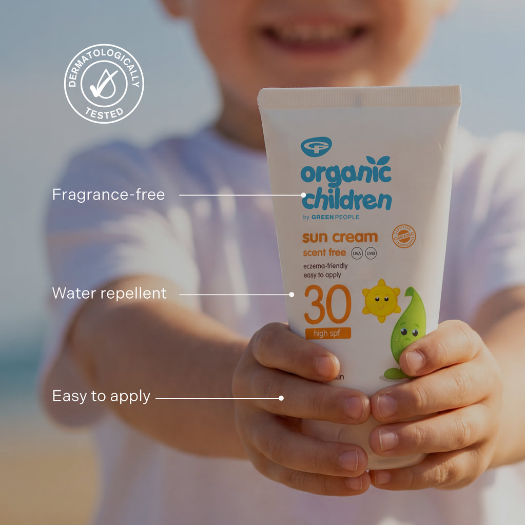 A child holds a white tube of Organic Children Scent Free Sun Cream SPF30 with key product features highlighted on screen.