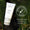 A white tube of Green People Scent Free Shower Gel 200ml rests on lush green moss beside a dermatologically tested seal.