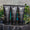 Three black Green People for Men tubes, featuring the No. 1 Exfoliating Face Scrub, arranged on a tray with green leaves behind.