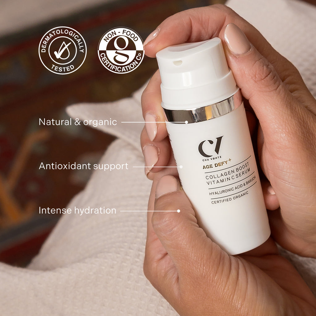 Hands hold the Age Defy+ Collagen Boost Vitamin C Serum bottle, highlighting its natural formula, antioxidants, and intense hydration.