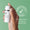 A hand holds a white pump bottle with a silver band, tilted slightly, against a green background with text overlays.