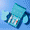 An open teal box displays three skincare products inside the Oy Clear Skin Goals Gift Set against a vibrant blue background.